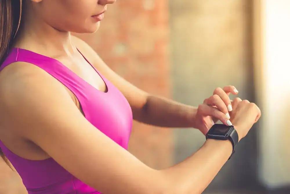 Cropped,Image,Of,Beautiful,Sports,Girl,Is,Switching,On,Her fitbit